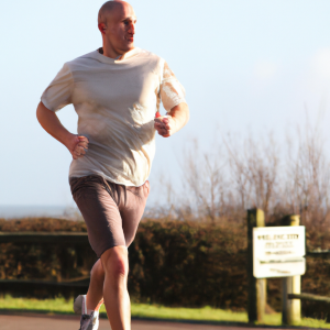 a professional appealing image of a caucasian man or woman jogging on a sunny day