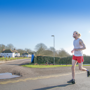 a professional appealing image of a caucasian man or woman jogging on a sunny day