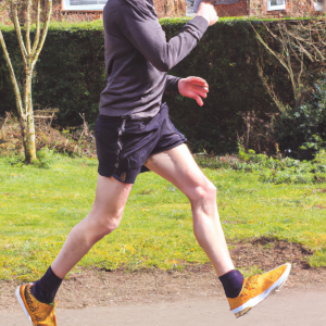 a professional appealing good looking and atheletic image of a caucasian man exercising or playing sports outside on a sunny day