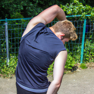 a professional appealing good looking and atheletic image of a caucasian man exercising or playing sports outside on a sunny day